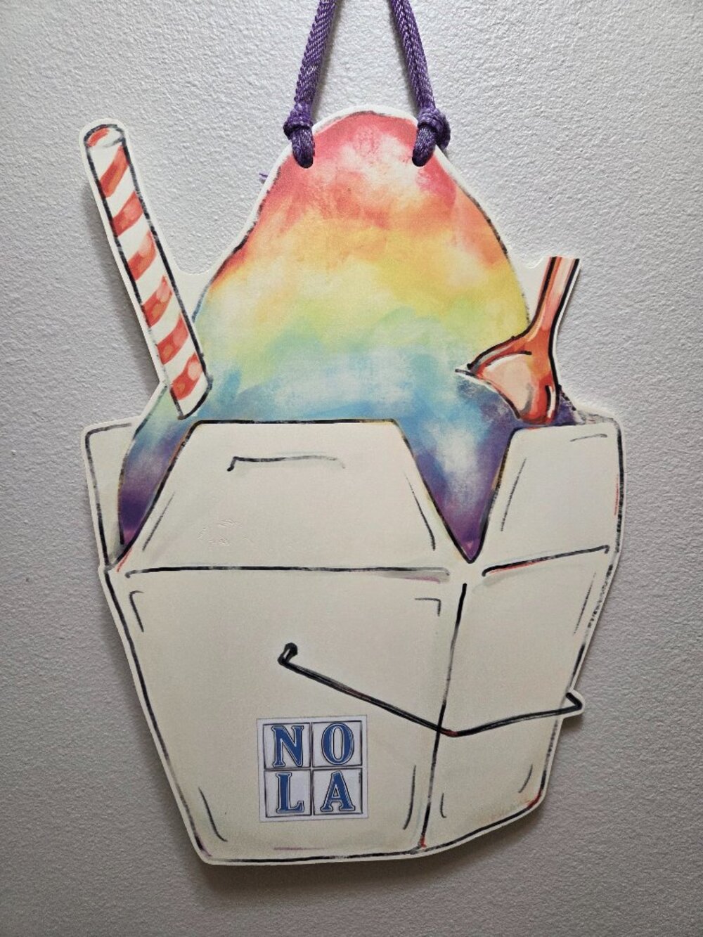 Colorful NOLA Sno-Ball door hanger shaped like a takeout box with a rainbow snow